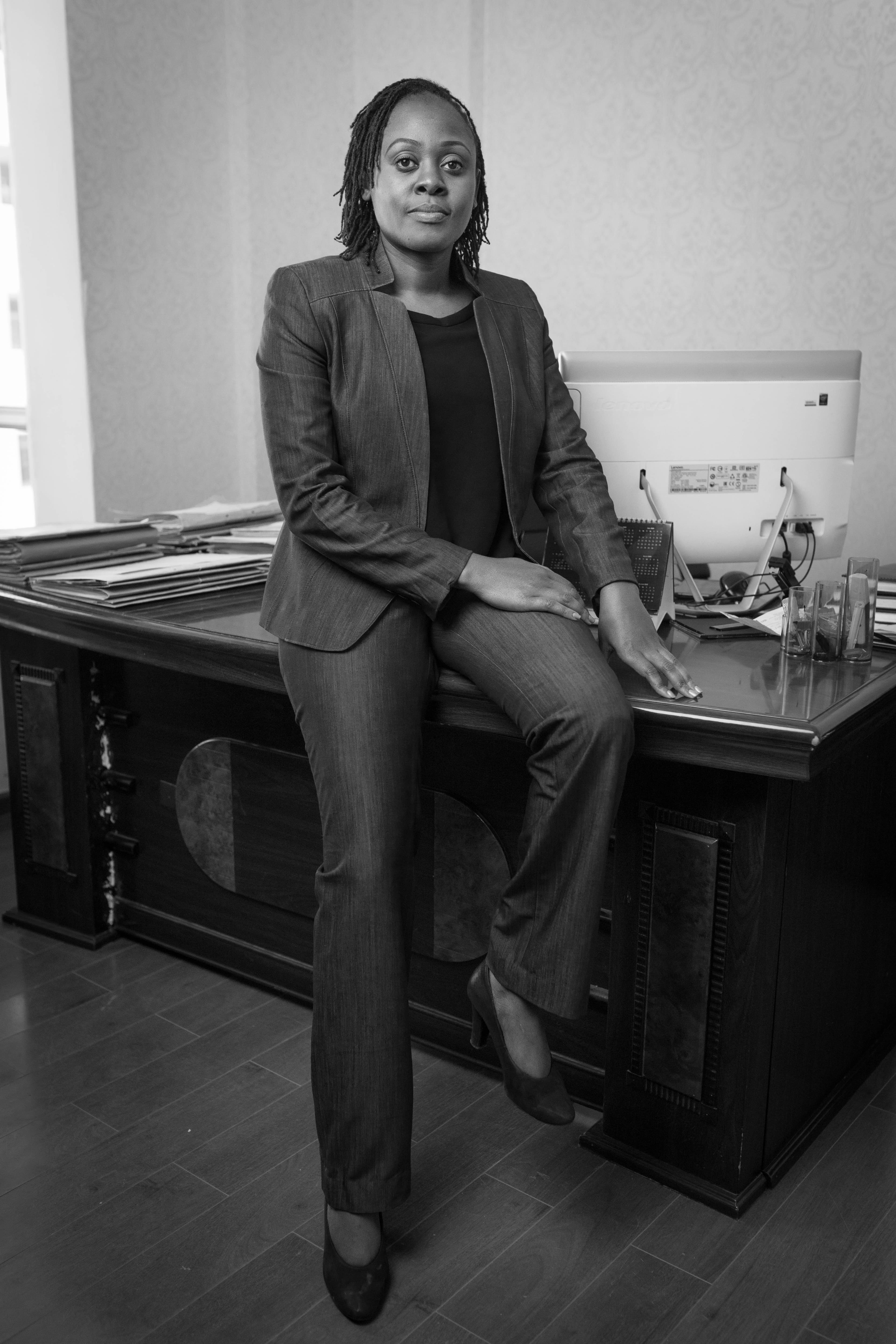 Editorial portrait of the principal advocate seated in her office